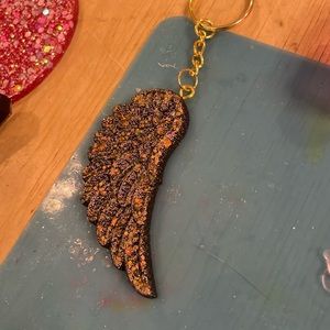 Black and bronze angel wing resin keychain